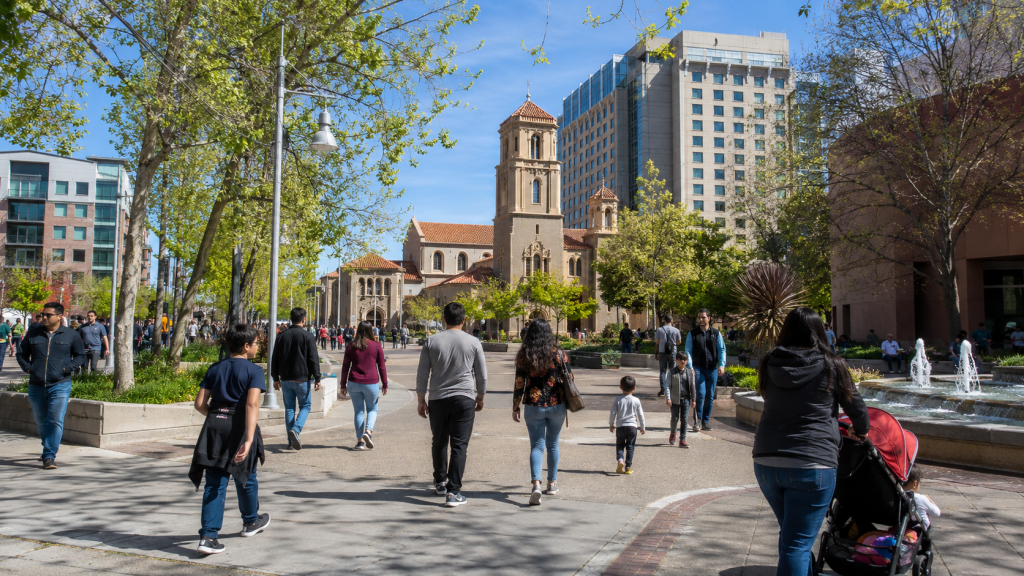 Visitors walking between Plaza de Cesar Chavez and downtown San Jose cultural attractions